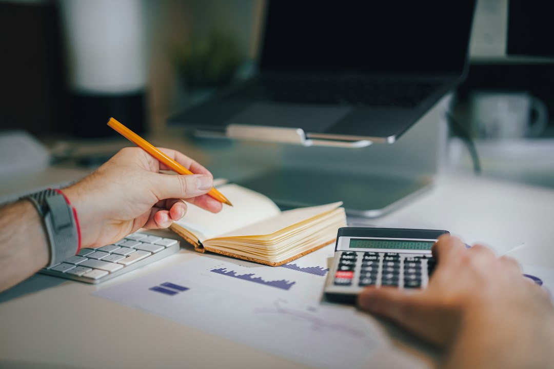 Calculator and international currencies representing multi-entity finance consolidation